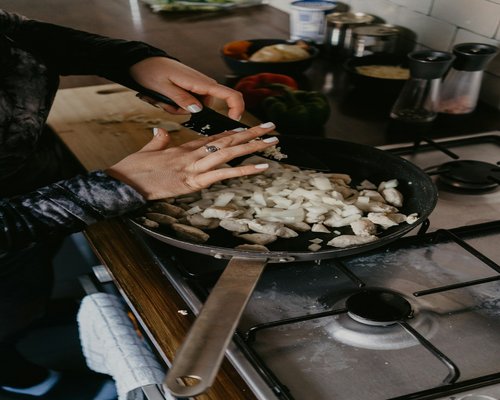 Person preparing a healthy meal with fresh ingredients in the kitchen
